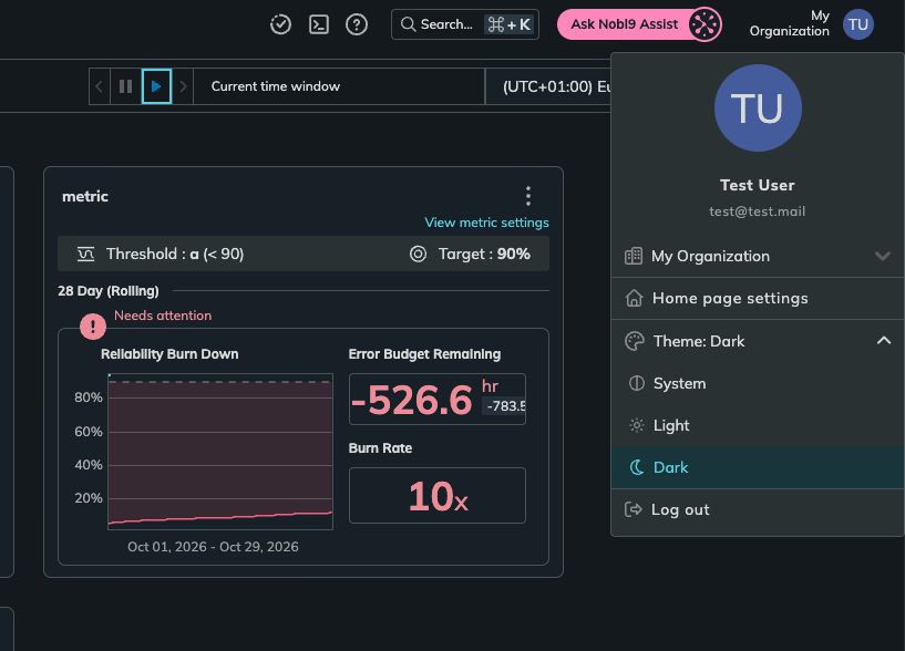 Nobl9 Web in the dark theme with the user menu open and the Theme options System, Light, and Dark
